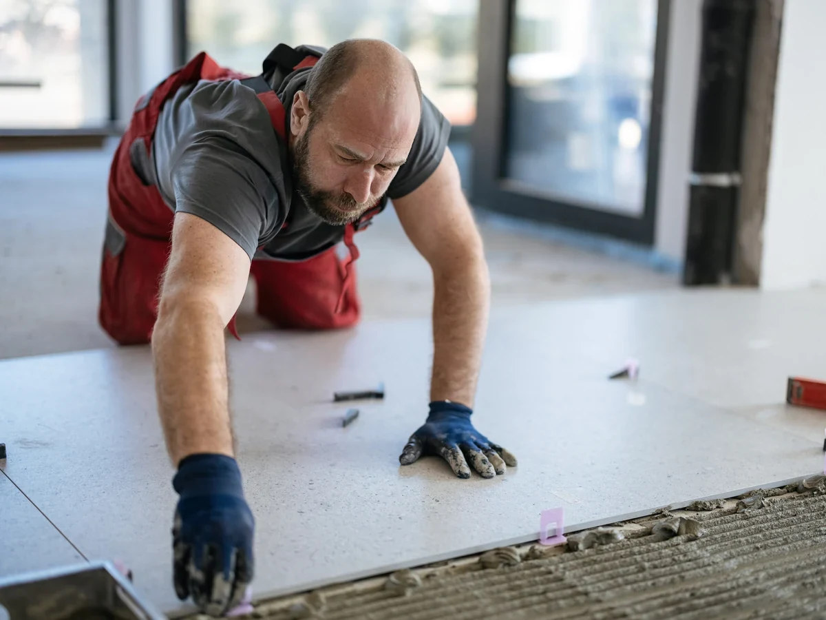 professional tiler measuring wall tiles daffodil tiling